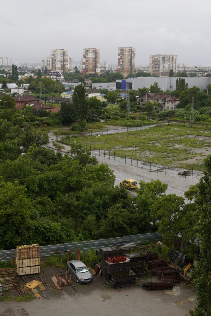 Urban view with apartments and wet road