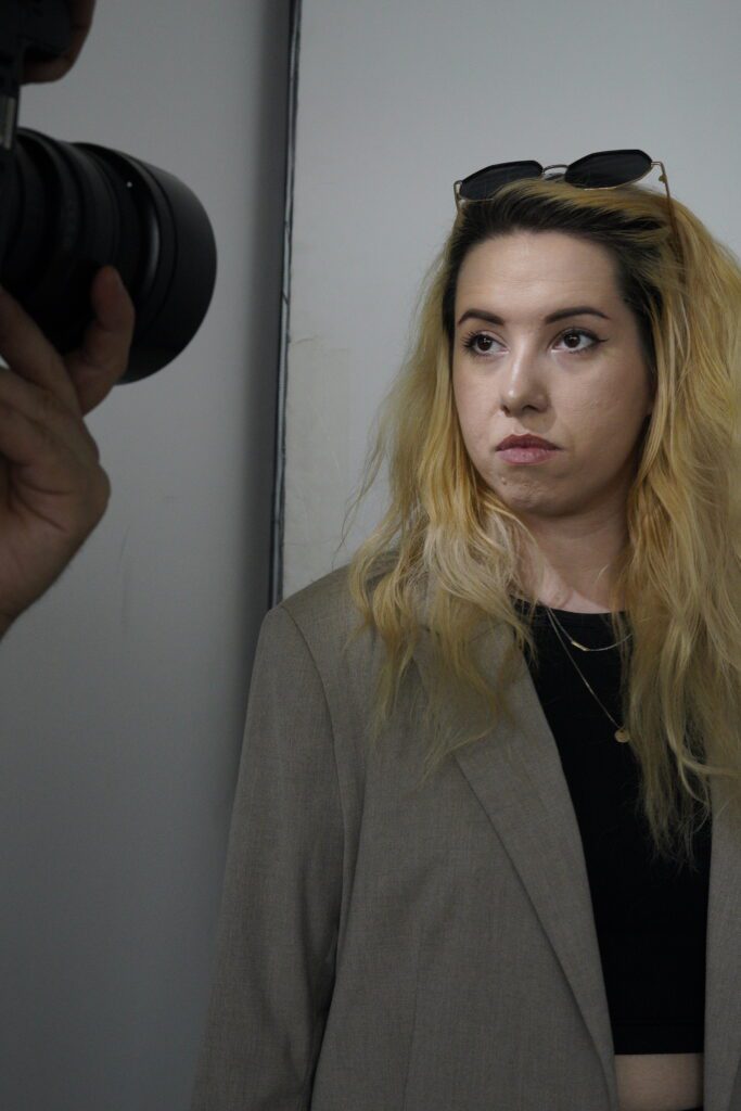 Portrait subject with camera in foreground