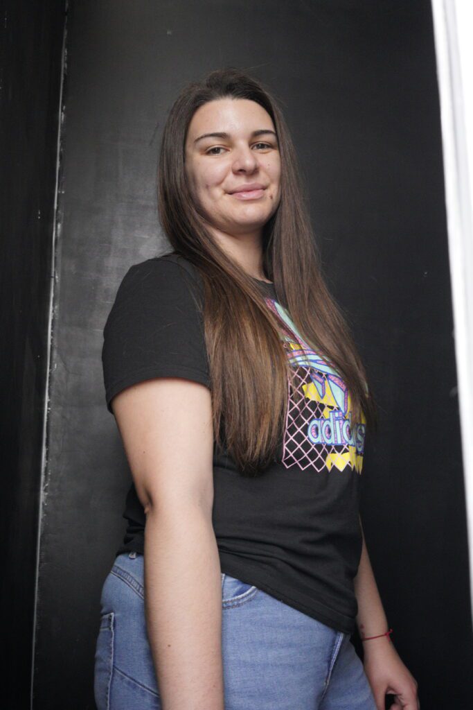 Portrait in graphic tee on dark backdrop