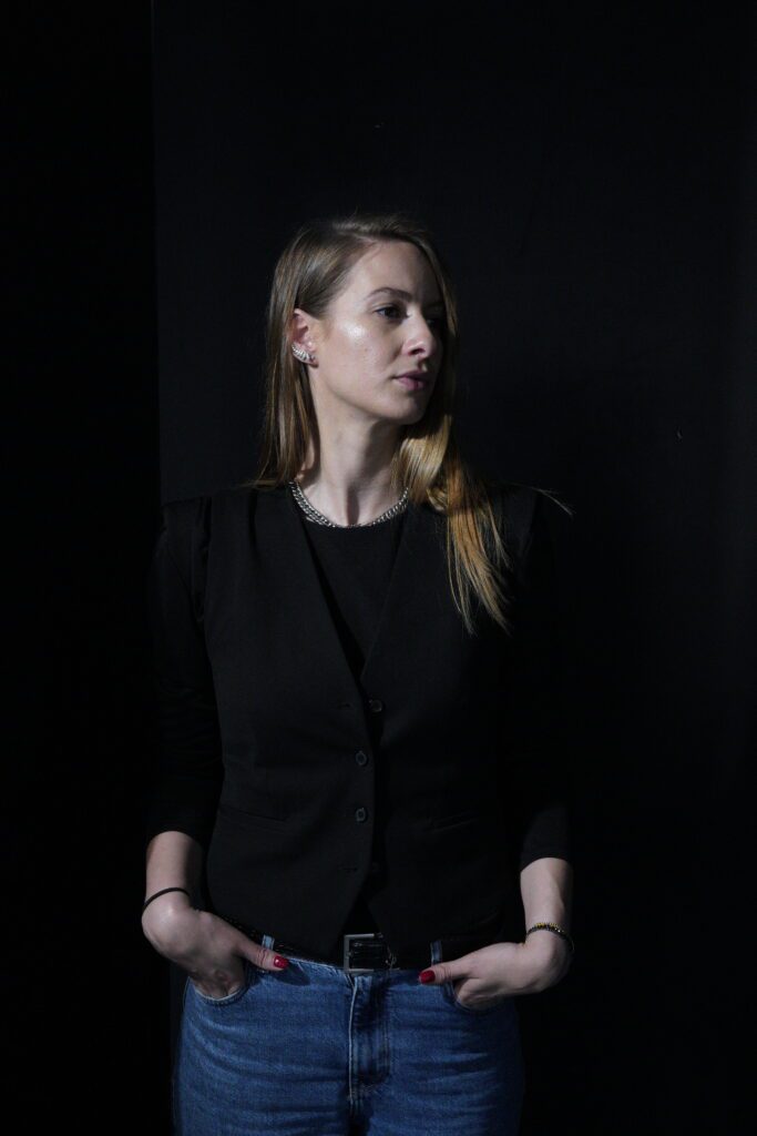 Side-lit waist-up portrait in black