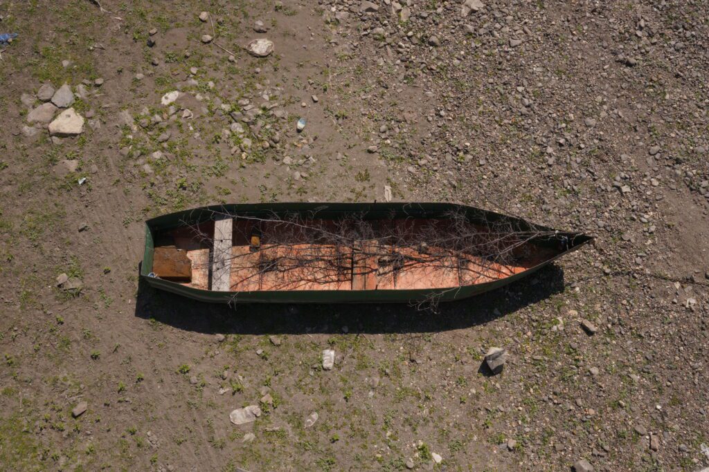 Green boat stranded on dry ground