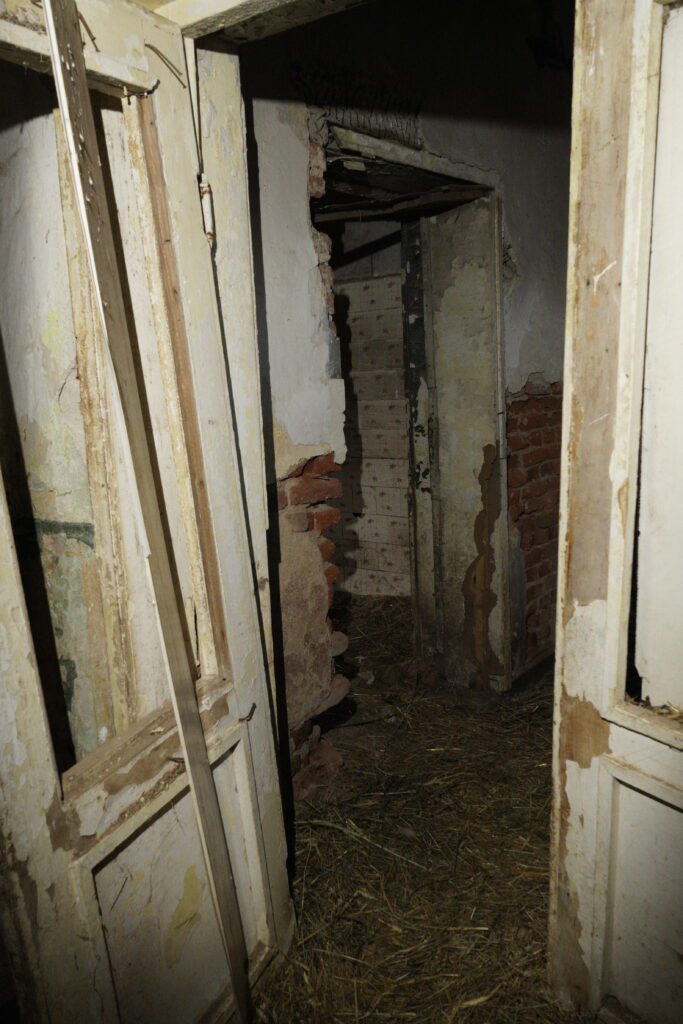 Straw floor through a ruined doorway