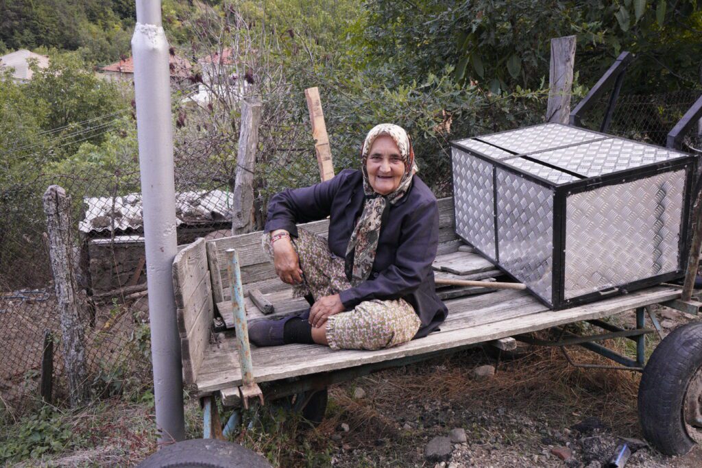 Woman smiling on a wooden trailer