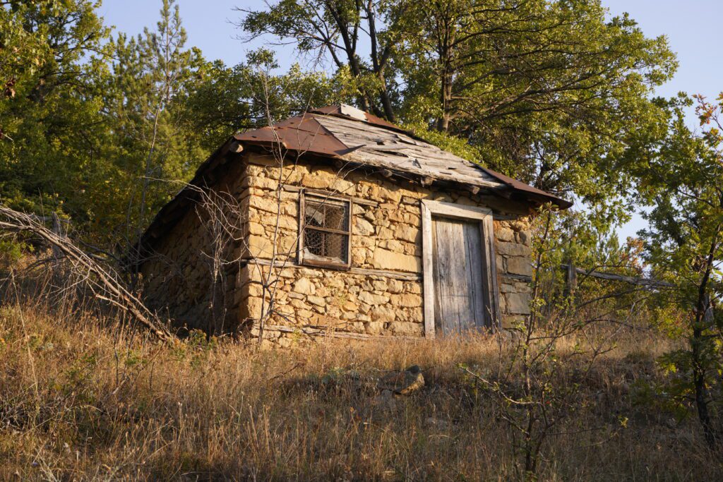 Abandoned stone hut on the hillside