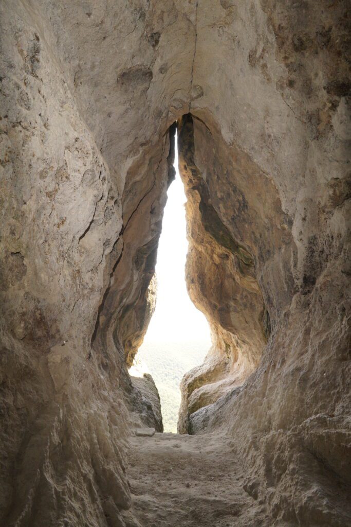 Cave slit toward green hills