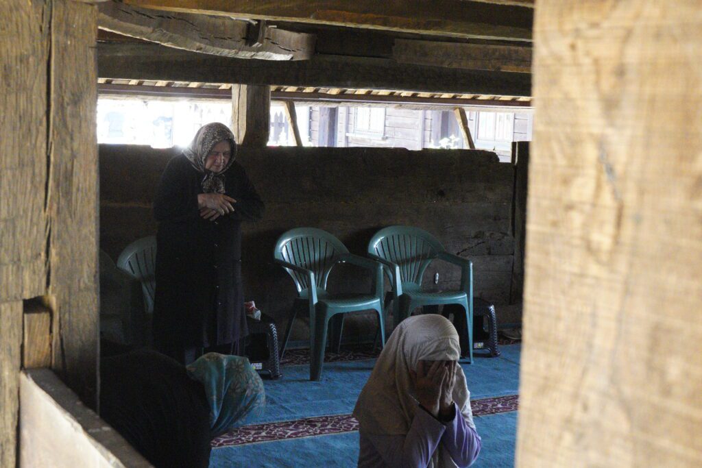 Women praying inside the wooden mosque