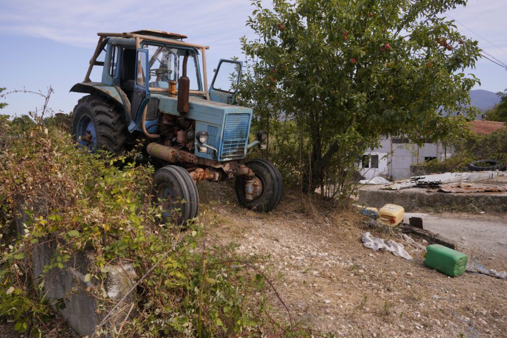 Blue tractor by the apple tree