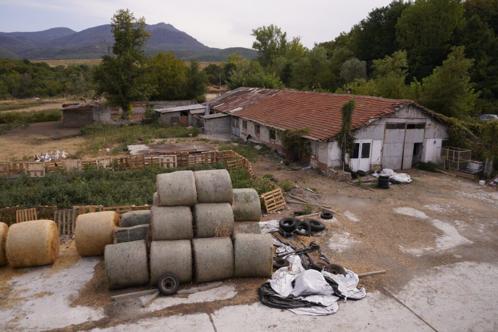Hay bales and valley farmstead