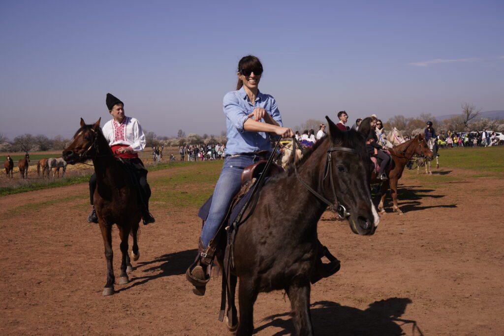 Rider in folk costume beside companion