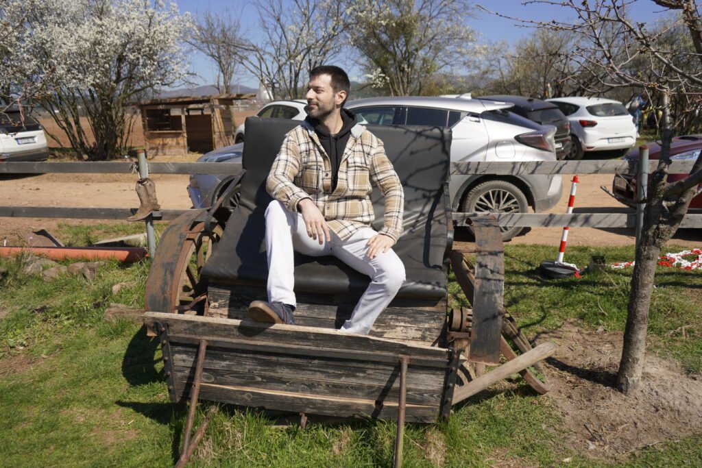 Man seated on wooden horse carriage