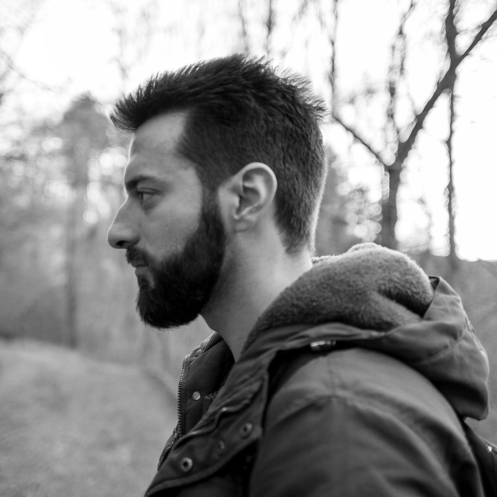 Black and white profile portrait of Todor Stoyanov with a beard, wearing a hooded winter jacket outdoors